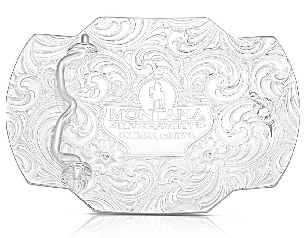 Back. Take flight with the Tail Wind belt buckle! Featuring a black backdrop, a golden eagle soars through detailed silver filigree that mimics swirling winds. Crafted Turquoise stones add a pop of color in opposite corners of this rope-edged, rectangle buckle. Measuring about 4.25" wide by 3.25" tall, it fits belts up to 1.5" wide. Snag one at our Smyrna, TN shop—just a quick drive from downtown Nashville! Made by Montana Silversmith.