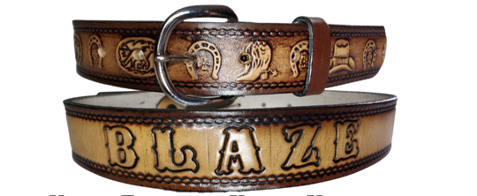 This leather belt showcases artwork of boots, horseshoes, and a hat, and is a fashionable addition to any wardrobe. The metal buckle is removeable, making it easy to customize your buckle. Stocked in our Tennessee location, you can get it quickly with our Quick Ship option.