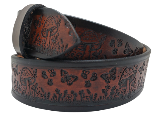 Our 1 1/2" Throwback Groovy Mushroom is a solid strip of USA veg-tan cowhide, embossed with a scene of Mushrooms, Flowers, and Butterflies down length of belt. It is hand finished in 3 finishes, with smooth beveled, and painted edges, approx. 1/8" thick. Sizes available are 34" to 44" from buckle end to hole most worn.  Buckle is an Antique Silver finish brass, held in place with 2 snaps for easy buckle change. Crafted by hand at our Smyrna, Tennessee shop, close to Nashville.