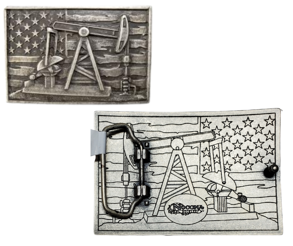 The Pump Jack Buckle features a rectangular design showcasing an oil rig pump jack against a weathered American flag backdrop. Crafted from zinc and iron with a dark antique silver finish, it measures about 2 1/2" by 3 3/4" and fits a standard 1 1/2" belt. Grab yours online or visit our Smyrna, TN shop near Nashville to add some rugged charm to your look!