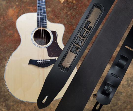 Acoustic Guitars and Great Songs and Lyrics have been staple for years in Country music!  "This 2" or 2 1/2" wide Guitar Strap is a nod to that classic influence. The main Body of the strap is approx. 1/8" thick Black Leather Strap with a CUSTOMIZABLE LEATHER NAME PATCH. The classic adjustment style goes from approx. 42" to 56" at it's longest . Made just outside Nashville in our Smyrna, TN. shop. It will need a bit of time to "break in" but will get a great patina over time.