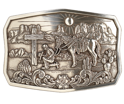 This handsome, one-of-a-kind buckle displays an antiqued silver finish, an old wooden cross, and a cowboy in prayer to our Lord, all against a hot desert backdrop. At approx. 2 1/2" tall and 3 1/2" wide, it fits belts up to 1 1/2" wide and is available for purchase from our physical store in Smyrna, Tennessee as well as our online store. Imported.