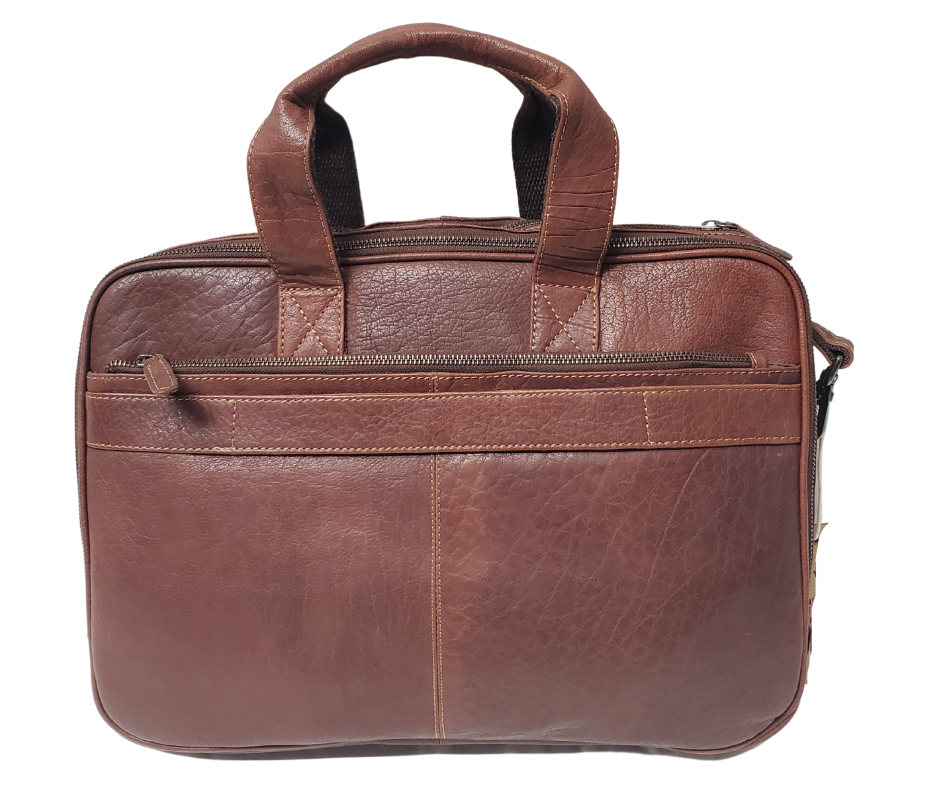 The Colonel Leather Laptop Bag is a no-frills bag that's perfect for the daily hustle. Crafted from buttery soft pebble grain leather, it only gets better with age. With a spacious main pocket, computer sleeve, and room for paperwork and snacks, it's got your weekday needs covered. Power cords? No problem! Just stash them in one of the two outside zippered pockets. And for ultimate convenience, it comes with an adjustable shoulder strap. Swing by our Smyrna, TN shop and snag one today!