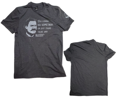  If you like Tombstone, Doc Holliday, Wyatt Earp you will want this. You know all the great one liners from Doc. Turn on your favorite Wayne or Eastwood movie and your good to go!  Available online and in our retail shop in Smyrna, TN.  Image on the front chest area, brand logo on left sleeve  Made of super soft 100% cotton 