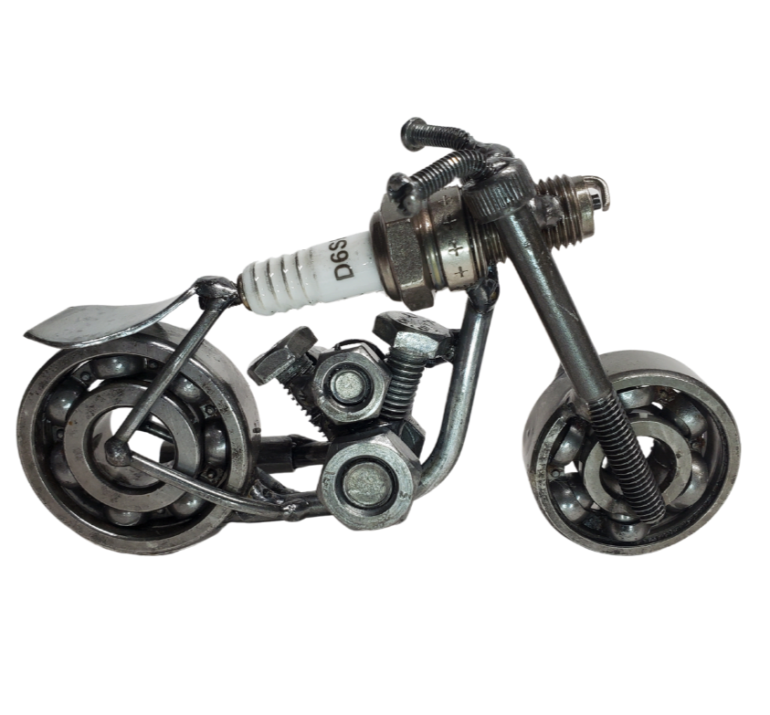 The perfect addition to your Man Cave! This metal art piece is a unique gift for any motorcycle enthusiast. Featuring nuts, bolts, springs, and bearing wheels, even a spark plug. It even stands on it's own. Need more details? Take a look at the picture for dimensions. This is our smallest motorcycle piece in stock, and you can find it at our store in Smyrna, conveniently located just outside Nashville, TN.