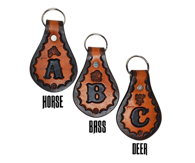 Our 1970 throwback style Leather keychain is hand stamped similar to our popular belts.  Great for identifying luggage, backpacks, or your keys! Available in the below choices All colored in our popular 2 TONE BROWN, pick one or a few, makes great gifts! Made in our Smyrna, TN shop. Please type desired initial in CUSTOM box.