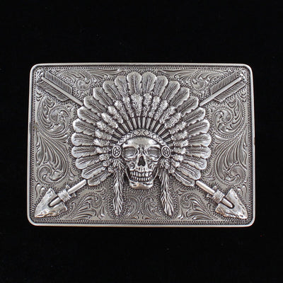 Ariat Indian Chief belt buckle Rectangle shaped buckle with a stylish smooth edge. It features a centered Indian chief skull with headdress and crossing arrows motif surrounded by western scroll engraving. Antiqued Chrome color. Measures 3-1/2" wide x 2-1/2" tall Fits belts up to 1 1/2" wide Available online or in our shop in Smyrna, TN just outside Nashville. Alternate view.