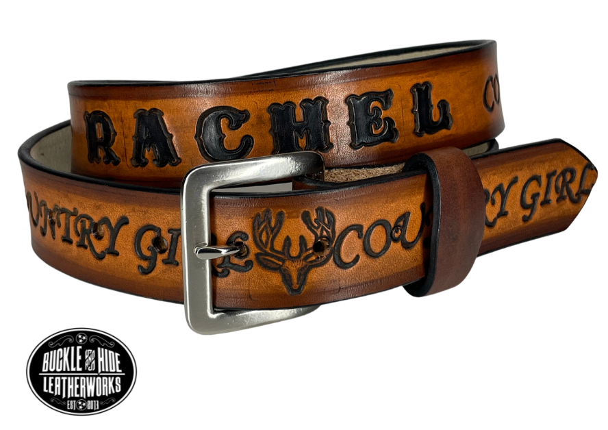 "The Country Girl" is a handmade real leather belt made from a single strip of cowhide shoulder leather that is 8-10 oz. or approx. 1/8" thick. It has hand burnished (smoothed) edges and YOUR CHOICE OF MOTIF DESIGNS in between each COUNTRY GIRL. The antique nickel plated solid brass buckle is snapped in place with heavy snaps.  This belt is made just outside Nashville in Smyrna, TN.  Choose 1 1/4" or 1 1/2" width.