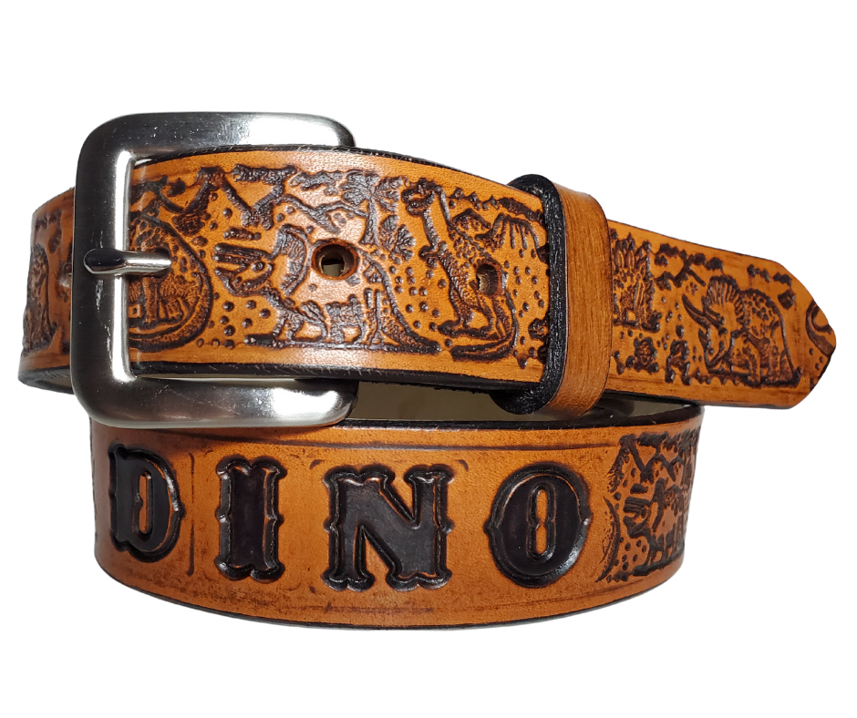 Our Lil Dino is perfect who love Dinosaurs! Full grain American vegetable tanned cowhide approx. 1/8"thick. Width is 1 1/4" and includes Antique Nickle plated Solid Brass buckle. We Hand Finish with each belt. Edges are smooth burnished painted edges. Made in our Smyrna, TN, USA shop. Buckle snaps in place for easy changing if desired.  Choose with or without name
