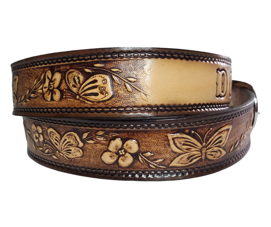 This stylish leather belt features beautiful flowers and butterfly artwork that is sure to draw attention. The easy-change metal buckle makes for comfortable wear and makes it easy to adjust for size. Perfect for adding a unique touch to any wardrobe. This belt is stocked in our shop outside Nashville in Smyrna, TN.