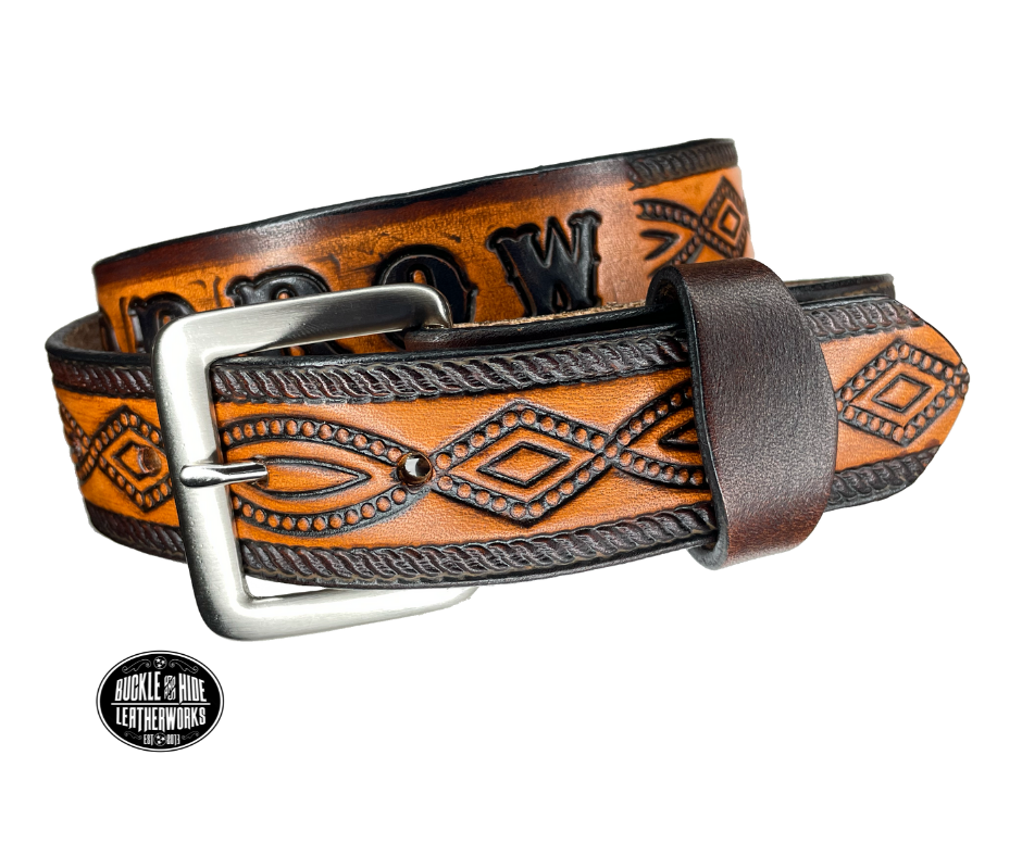 This solid strip of Veg Tan cowhide, is hand stained in classic 2 tone antique brown, with smooth, finished edges. Embossed with a classic FIGURE 8 pattern you'll see "The Stranger" wearing in well known "spaghetti" westerns down length of belt, or have name added to scene up to 8 letters. Belt thickness is approx. 1/8", and 1 1/2" wide. Sizes available are 34" to 44" from buckle end to hole most worn. Attached with 2 snaps is a Brushed Nickel plated solid brass buckle.