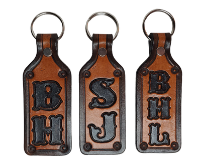 Our Customizable "1973" Medium Leather keychain embossed similar to our popular belts.  Great for identifying luggage, backpacks, or your keys! Available in the below choices All colored in our popular 2 TONE BROWN, pick one or a few. Made in our Smyrna, TN shop. 2 initials will be 1" size, 3 initials will be 3/4" size. Please type desired name in CUSTOM box.  Measures...approx. 1" x 4"