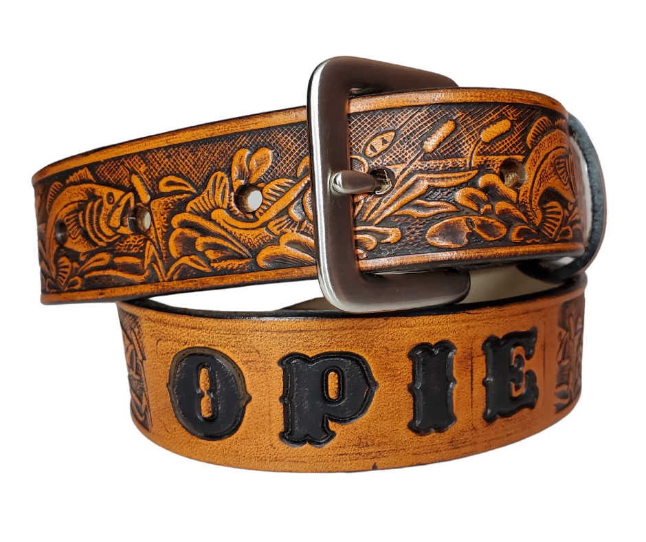 Our Lil Fishin' is just like the Fishin' for dad or mom. Full grain American vegetable tanned cowhide approx. 1/8"thick. Width is 1 1/4" and includes Antique Nickle plated Solid Brass buckle. We Hand Finish with a tan center. Edges are smooth burnished painted edges. Made in our Smyrna, TN, USA shop. Buckle snaps in place for easy changing if desired.  Choose with or without name,