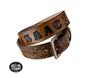 Introduce your little one to the iconic style of the west with the "Lil' Mustang" Leather KIDS/CHILDRENS Name Belt! Durable veg tan leather ensures that your cowboy or cowgirl can look good while feeling comfortable, and a unique western floral design featuring horses adds a touch of fun. A 1 1/4" width with snaps makes swapping out buckles a snap! Proudly made in Smyrna TN, just outside Nashville. 