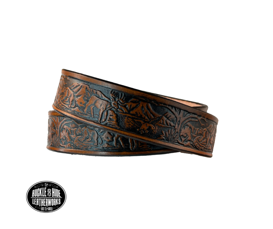 Perfect for the LIL Outdoors type the Wilderness scene embossed on veg tanned cowhide belt, about 1/8" thick, 1 1/4" width, burnished painted edges. The buckle easily snaps into place, allowing for easy changing when desired. Handcrafted with care in our Smyrna, TN shop, our Lil' Wilderness belt guarantees satisfaction. Follow our belt sizing instructions for a perfect fit