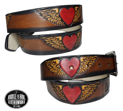 "The Love" is a handmade real leather belt made from a single strip of cowhide shoulder leather that is 8-10 oz. or approx. 1/8" thick. It has hand burnished (smoothed) edges and a Winged Heart pattern. This belt is completely HAND dyed with a multi step finishing technic or you can get in basic earth tones. The antique nickel plated solid brass buckle is snapped in place with heavy snaps.  This belt is made just outside Nashville in Smyrna, TN.