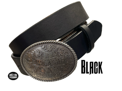 This oval shaped buckle by Nocona has a rope design around the border. It is chrome colored with scroll design etched appearance on surface.  Measures 2 3/4" tall by 3 3/4" wide and fits belts up to 1 1/2" wide. Buckle is made in Taiwan. Belt is a solid strip of leather and made in our shop in Smyrna, TN, just outside Nashville. It is 1 1/2" wide and available in sizes 34"-44" and colors distressed brown, black, and dark brown. It is available for purchase in our retail shop and online store. Black.
