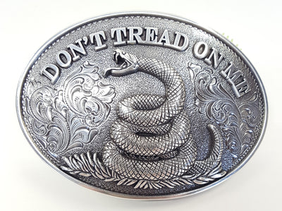 Oval shaped Nocona buckle Smooth edge and "Don't Tread On Me" motif Measures 2 1/2" tall by 3 1/2" wide Made in Taiwan Available online and in our shop in Smyrna, TN, just outside of Nashville