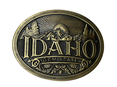 Idaho State buckle by AndWest Dimensions are 3" tall by 3 3/4" wide Fits belts up to 1 1/2" wide Buckle is brass colored with Idaho Gem State embossed across front of buckle. Mountain scene in the back behind "Idaho". Back of buckle has Western scroll design Available in our online store and in the retail shop in Smyrna, TN, just outside of Nashville. Made in Mexico