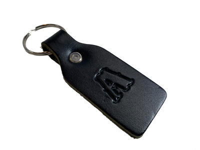 Small Leather keychain embossed with your choice of single letter initial. Great for identifying luggage, backpacks, or you keys! Available in Black or Assorted Brown. Put initial/s in the box. Made in our Smyrna Tn. shop.