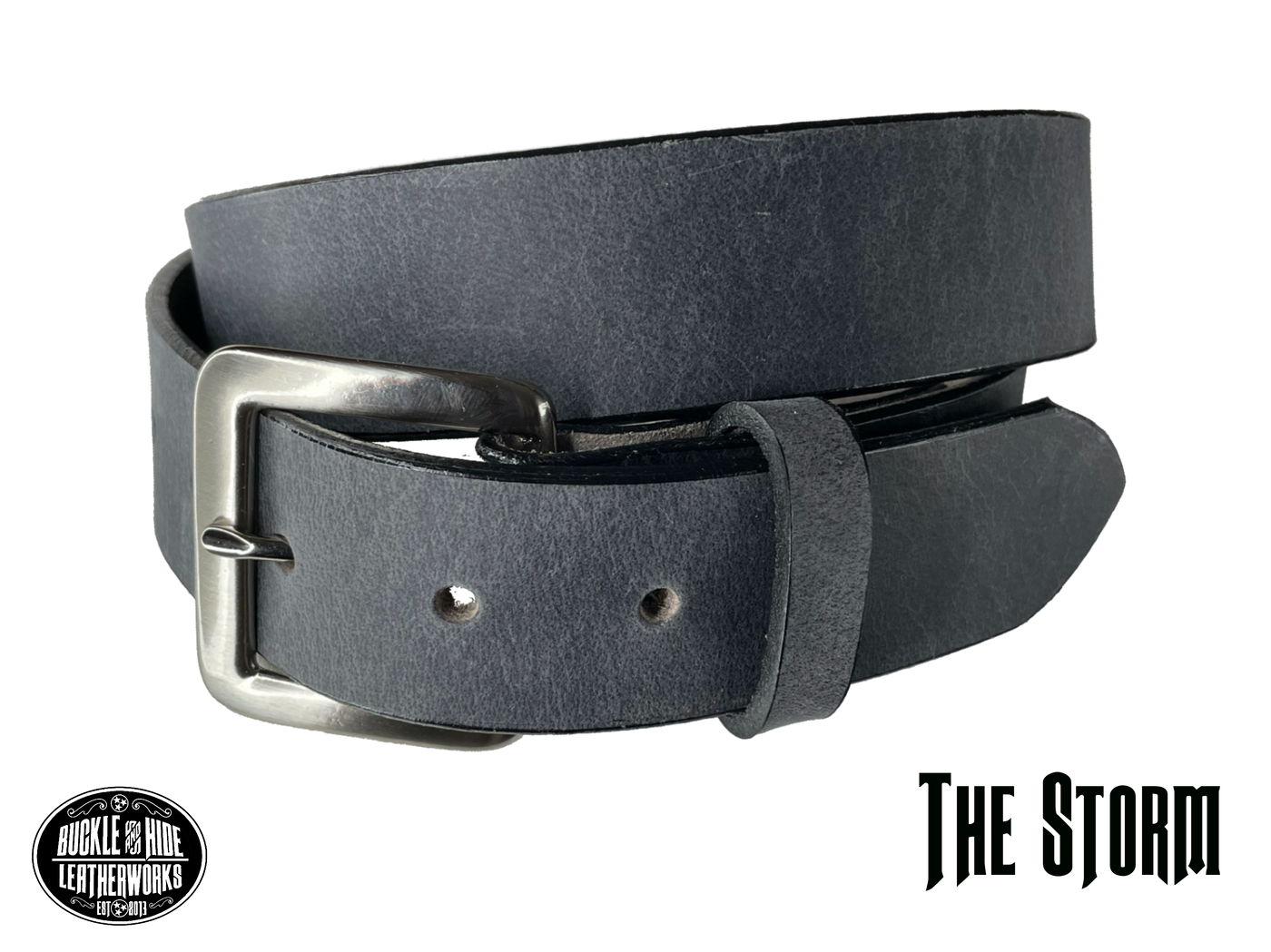 This gray leather belt is made from Crazy Horse tanned leather for that distressed and pull-up look. Choose with or without white stitching along the edges.  Has smooth black painted edges. It has an antique solid brass buckle that is snapped in place. Belt is 1 1/2" wide and available in lengths from 34" to 44".  It is handmade in our shop in Smyrna, TN, just outside of Nashville.