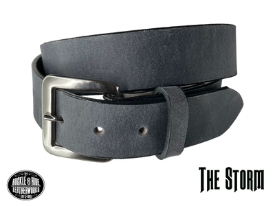 This gray leather belt is made from Crazy Horse tanned leather for that distressed and pull-up look. Choose with or without white stitching along the edges.  Has smooth black painted edges. It has an antique solid brass buckle that is snapped in place. Belt is 1 1/2" wide and available in lengths from 34" to 44".  It is handmade in our shop in Smyrna, TN, just outside of Nashville.