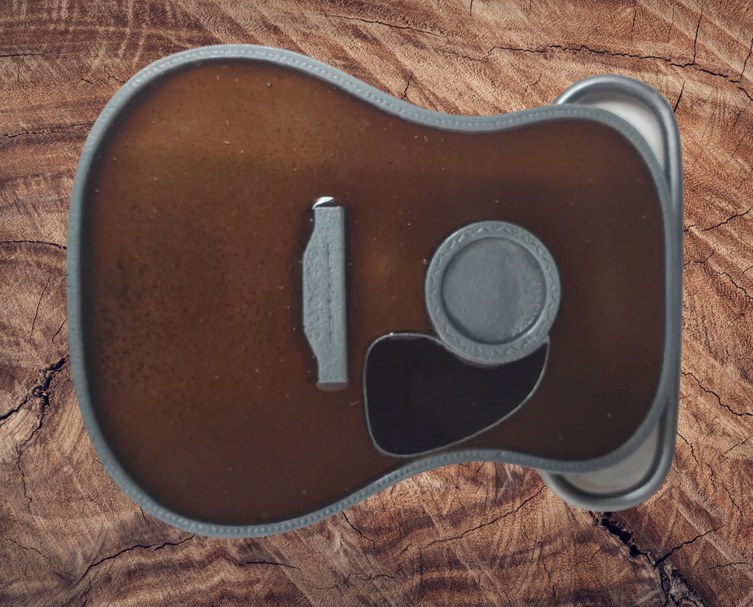 Strut your style with the iconic "Martin" Belt Buckle! This 2 1/2" tall by 3 1/2" wide buckle is fit for all music genres, from Rock to Bluegrass, Jazz to Folk. Let the world know your passion for playing guitar! Just outside of Nashville, home of the Acoustic Guitar, you can find the belt buckle in our Smyrna, TN shop online.