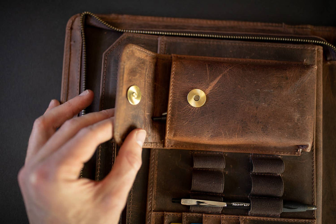 The Nomad Leather Portfolio is the perfect blend of rugged durability and professional style, designed to keep you organized wherever work takes you. Crafted from top-grain water buffalo leather, dedicated sleeve for a tablet, documents, and a letter size pad or planner insert. Whether you’re in the office, traveling, or working remotely, the Nomad Portfolio ensures you stay prepared in timeless leather craftsmanship. See them at our Smyrna, TN shop.