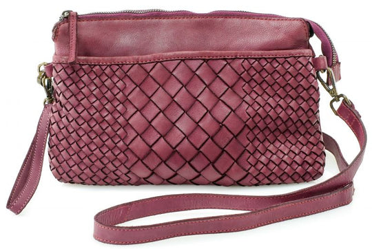 The Eve is made from soft tumbled leather and has a Woven front. The back side has a zippered pocket that will hold most smaller phone sized items. The main open inside pocket has one zippered pocket, 2 open top pockets 4 card size slots and one more smaller pocket next to to the cards. May be carried with the Wrist loop or as a Crossbody style with the included strap. The liner is a cotton fabric. Available now at our store in Smyrna, TN!

Measurements: 10" x 1" x 6"