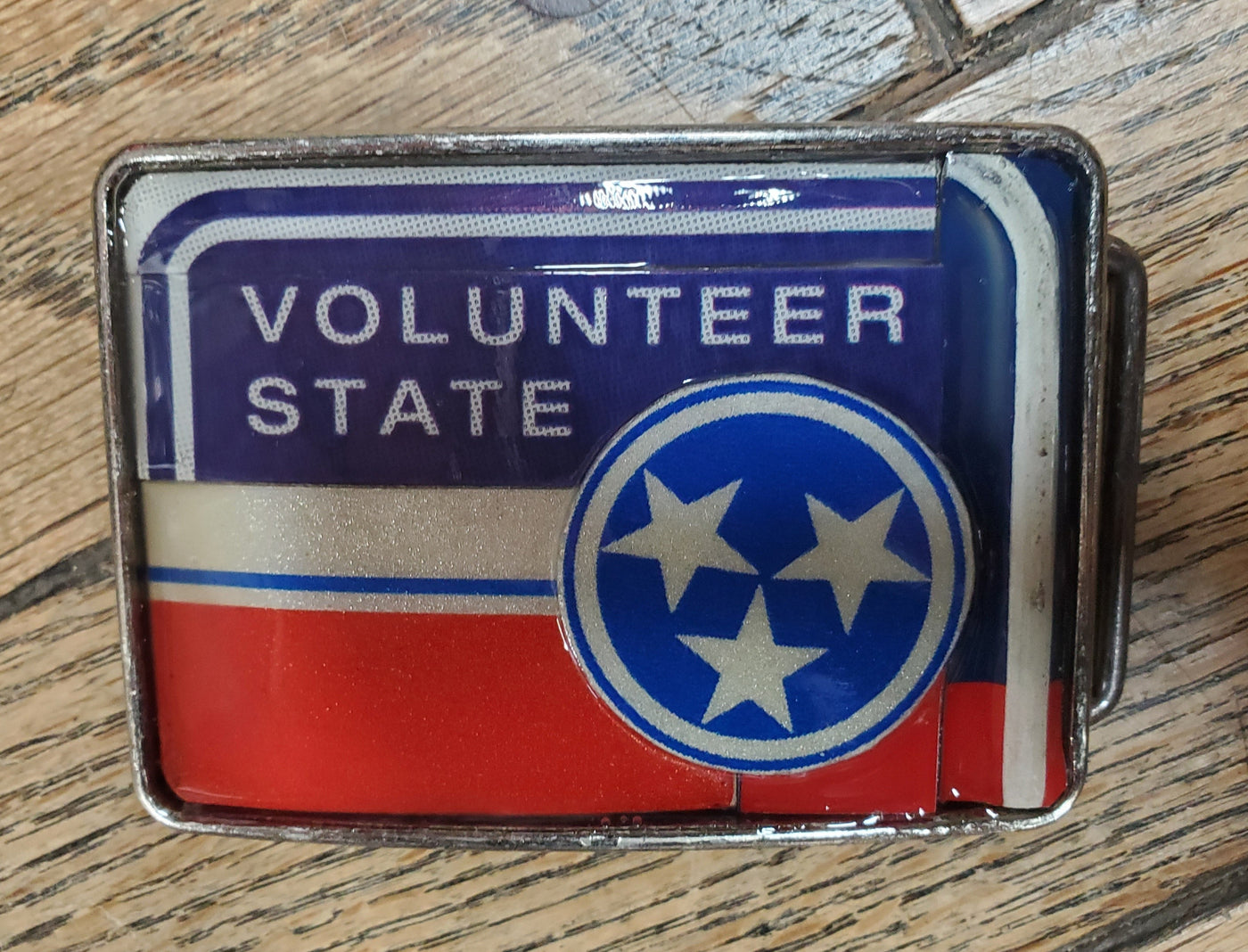 Hand Crafted Tennessee Volunteer look with our handmade license plate belt buckle. It's a great choice for cheering on your favorite Tennessee teams or for celebrating the great volunteer state! This eye-catching piece measures approx. 3" x 4" and can be matched with any 1 1/2" belt. Get yours today from our Smyrna, TN (near Nashville) store or online and show your style!