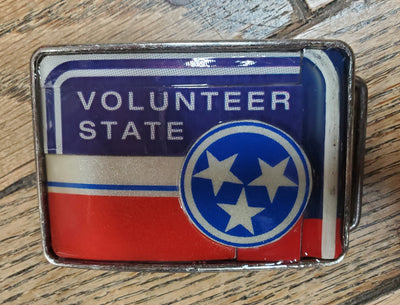 Hand Crafted Tennessee Volunteer look with our handmade license plate belt buckle. It's a great choice for cheering on your favorite Tennessee teams or for celebrating the great volunteer state! This eye-catching piece measures approx. 3" x 4" and can be matched with any 1 1/2" belt. Get yours today from our Smyrna, TN (near Nashville) store or online and show your style!