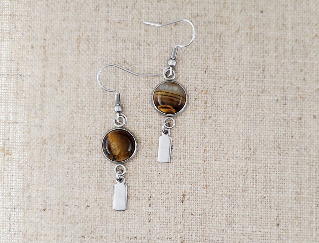 -The earrings are stainless steel with Tigers Eye stone -The ear wires are stainless steel. -The earrings measure 1/2" wide -They measure 1 7/8" in total length -Light weight -You will receive earrings similar to what is pictured here. Stocked at our Smyrna, TN shop down I-24 from downtown.