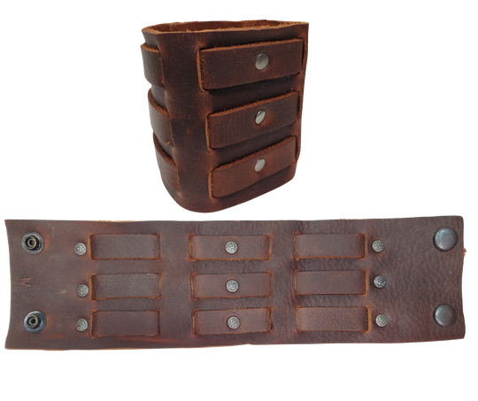 Show off your rocker style with our 2 3/4" Wide Laced Leather Cuff. Featuring three leather strips woven through a broad band, it channels that edgy Zack Wilde vibe. Crafted from soft leather, it promises a comfy fit all day long. Hurry—limited quantities available at our Smyrna, TN store!

PLEASE NOTE SIZING (see picture) SMALL 8", MEDIUM 8 1/2", LARGE 9". Sizing may vary slightly with each cuff.
