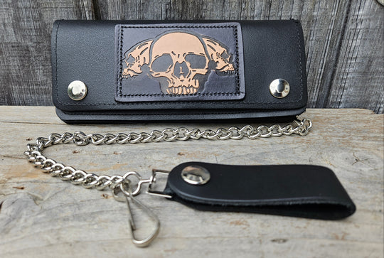 3 Skulls pattern all leather patch on a Classic Style Chain Wallet, great for the Modern minimalist. One credit card slot in the front with 2 main cash or whatever your STUFF is....5 year old receipts, concert stub from high school, the stuff you forgot was in there! Available in our Smyrna, TN shop a short drive from downtown Nashville. Like most wallets with over stuffing will limit the time of use. 