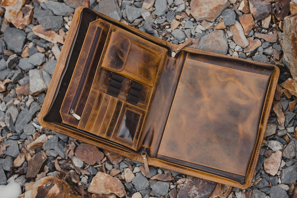 The Nomad Leather Portfolio is the perfect blend of rugged durability and professional style, designed to keep you organized wherever work takes you. Crafted from top-grain water buffalo leather, dedicated sleeve for a tablet, documents, and a letter size pad or planner insert. Whether you’re in the office, traveling, or working remotely, the Nomad Portfolio ensures you stay prepared in timeless leather craftsmanship. See them at our Smyrna, TN shop.