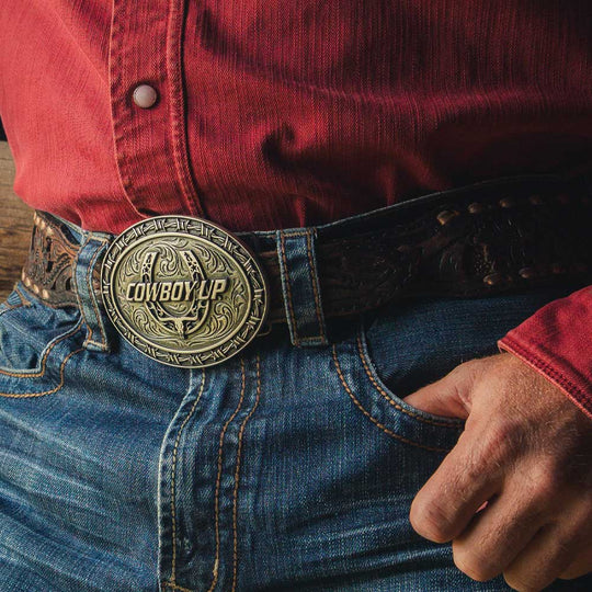 Featuring the words "Cowboy Up" over a horseshoe design. The horseshoe has a steer&