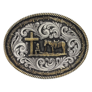 This large oval two tone Classic Impressions Attitude belt buckle features a highly detailed traditional gold tone Christian cowboy figure surrounded by classic silver tone filigree edged with gold tone barbed wire and twisted rope. Classic western filigree markings decorate the back for added detail. Fits 1 1/2" belts and is approx. 3 1/2" tall x 4 1/2" across. Available at our shop just outside Nashville in Smyrna, TN. Made by Montana Silversmith.