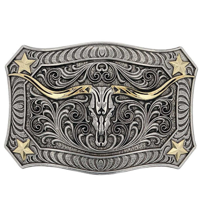 The Longhorn Crest Filigree Belt Buckle is free-spirited and has a western ruggedness. It holds a longhorn skull in the center that is cradled by exaggerated filigree. A mix of silver and gold tones give added depth and character. Each corner has a star and additional filigree while the buckle is framed in a smooth wire-like trim. Fits 1 1/2" belts and is approx. 3" tall x 4"across. Available at our shop just outside Nashville in Smyrna, TN. Made by Montana Silversmith.
