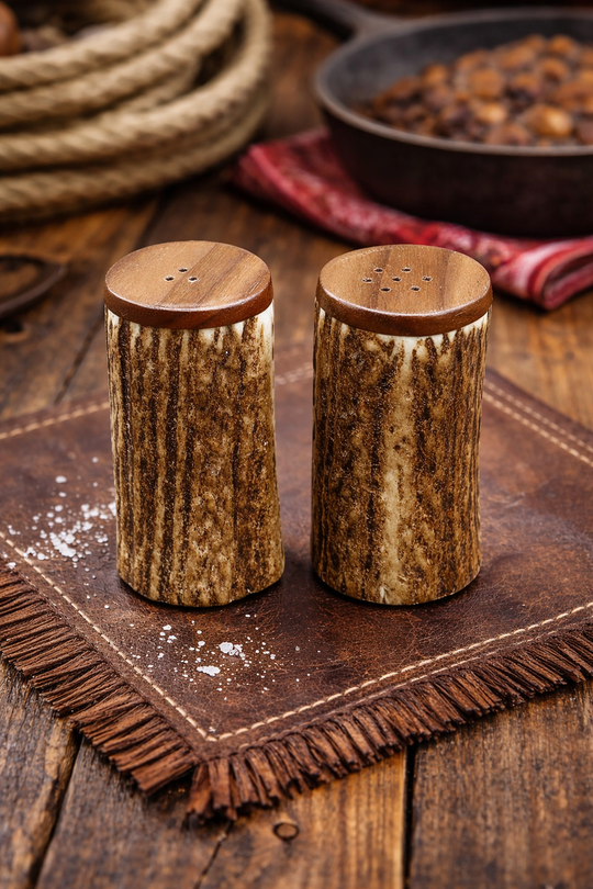 Handcrafted Antler Salt and Pepper Shaker set Made in U.S.A. Measures 3" tall x1 3/4" diameter top. Made from naturally shed elk and deer antlers with Walnut top and antler base. Sizes, colors and shape will vary. Made in the U.S.A. Get yours at our Smyrna, TN shop not far from Franklin.