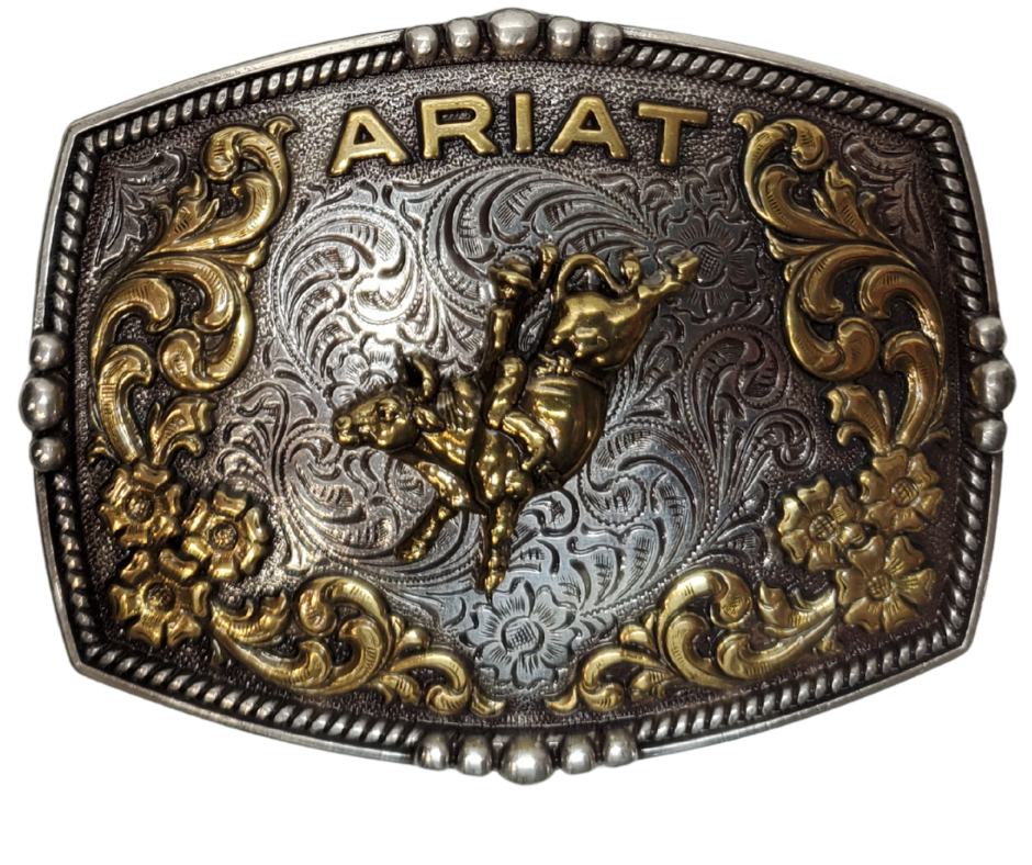 This new Ariat Bull Rider Western Buckle has Bordered with a beaded rope design, is an etched antiqued silver background. In a brass color, Ariat is arched across the top with raised scroll and flower designs surrounding a bull with rider. Measures about 2 3/4" tall by 3 1/2" wide. Fits belts up to 1 3/4" wide. Available for purchase in our online store or the retail shop in Smyrna, TN, just outside Nashville. Imported