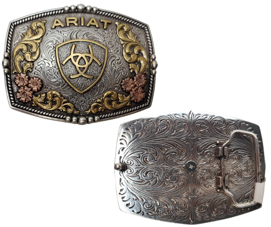 Ariat logo centered in the center and written across the top. Surface also has Classic Western Tri-Color scroll and flower designs and rope design with beads and rope around the border of the buckle. Color is antique silver with brass and bronze accents. Measures about 2 3/4" tall by 3 1/2" wide. Fits belts up to 1 3/4" wide. Available for purchase in our online store or the retail shop in Smyrna, TN, just outside Nashville. Imported