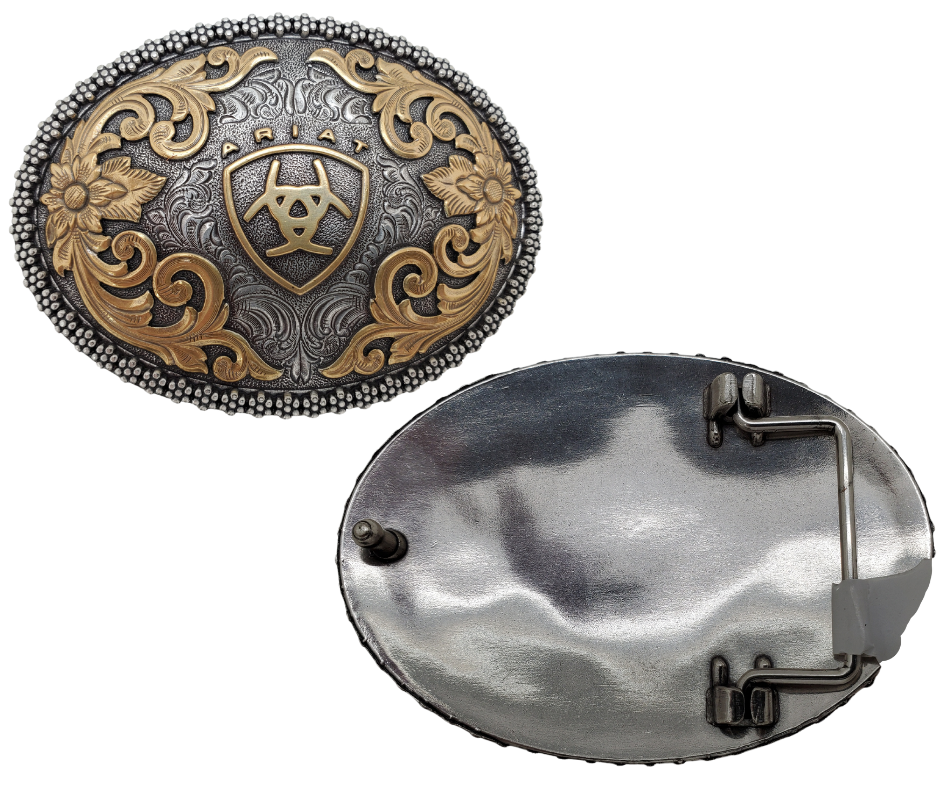 This beautiful oval buckle from Ariat features an ornate edge and an Antique and Brass colored Western scroll design surrounding the iconic Ariat logo. It's 3" tall by 4" wide and can fit belts up to 1 1/2" wide. You can find it at our retail shop in Smyrna, TN, near Nashville, or purchase it from our online store.