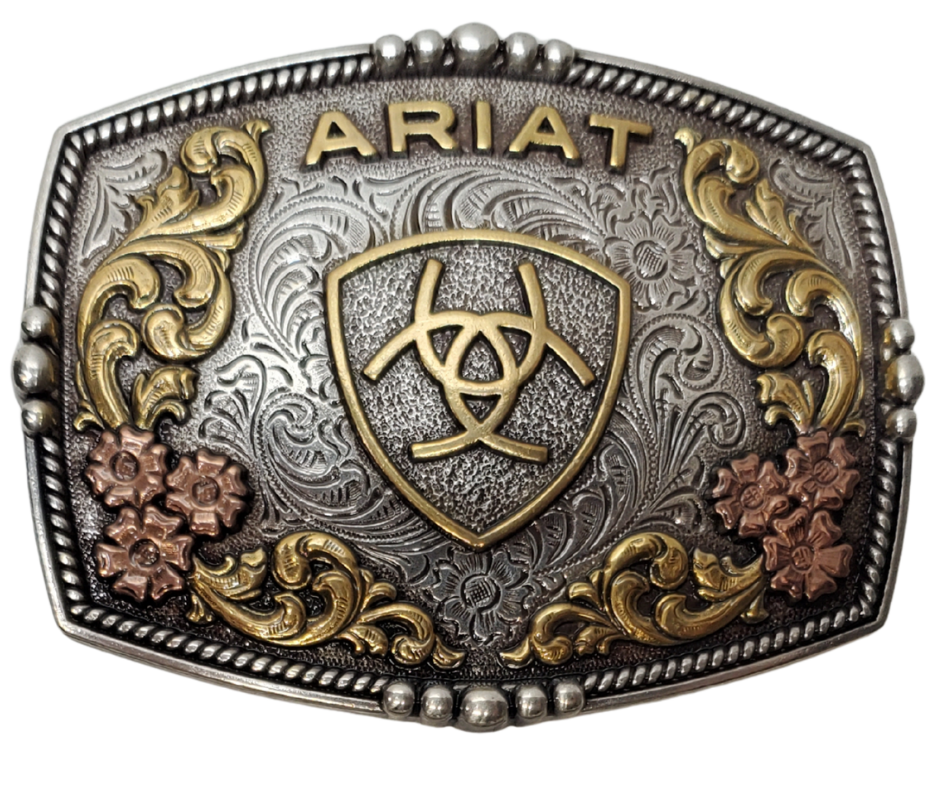 Ariat logo centered in the center and written across the top. Surface also has Classic Western Tri-Color scroll and flower designs and rope design with beads and rope around the border of the buckle. Color is antique silver with brass and bronze accents. Measures about 2 3/4" tall by 3 1/2" wide. Fits belts up to 1 3/4" wide. Available for purchase in our online store or the retail shop in Smyrna, TN, just outside Nashville. Imported

