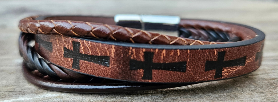 Multi leather strand bracelet with a easy connecting magnetic clasp. Wear everyday or just when your hanging out with friends getting coffee. The Cross is a symbol of deliverance that you can state your faith in a simple way. "We believe" too at our Smyrna, TN shop not far from Salvation By Grace church.

Approx. 8" Length