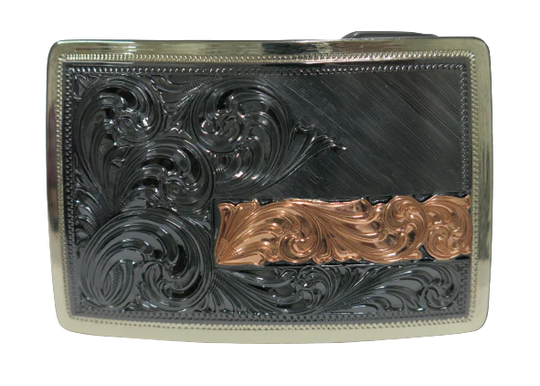 The Illusive is an attractive small, low-profile buckle engraved with a western scroll and diagonal lines. Crafted using a German Silver base, the border is a silver color, while the background is a gunmetal black, accented with a rectangular copper strip running through 2/3rds of the lower half of the buckle. Available in our Smyrna, TN shop, a short distance from Nashville.&amp;nbsp;

Dimensions: Width 3”, Height 2”

Standard 1.5” Swivel