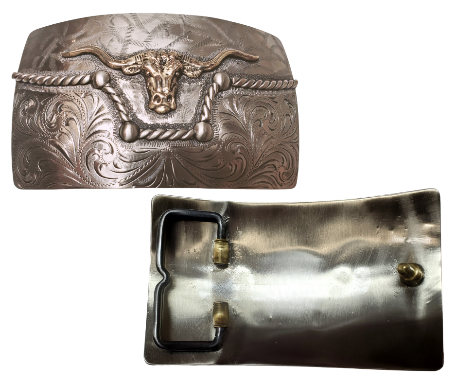 The River Horn impresses with an idea of a longhorn cattle neck deep in a river. In German Silver, the lower half of buckle is engraved in swirls forced from the center. It is separated from the lightly patterned top half with a rope dipping in the center to reveal the brass colored head of a Longhorn cattle. Available in our Smyrna, TN shop, a short distance from Nashville.