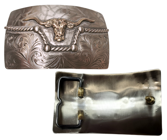 The River Horn impresses with an idea of a longhorn cattle neck deep in a river. In German Silver, the lower half of buckle is engraved in swirls forced from the center. It is separated from the lightly patterned top half with a rope dipping in the center to reveal the brass colored head of a Longhorn cattle. Available in our Smyrna, TN shop, a short distance from Nashville.