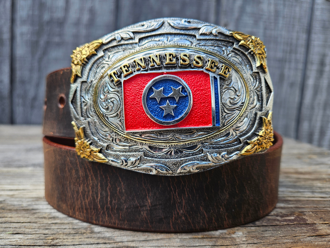 This Tennessee State Flag Belt with Buckle Combo features a 1 1/2" strap. Choose color: Distressed Brown or Black. The edges are beveled and finished. Available lengths from 34" to 44". The buckle is an Antiqued brass colored Tennessee State Buckle snapped in place. Belt is handmade in our shop in Smyrna, TN, just outside of Nashville.