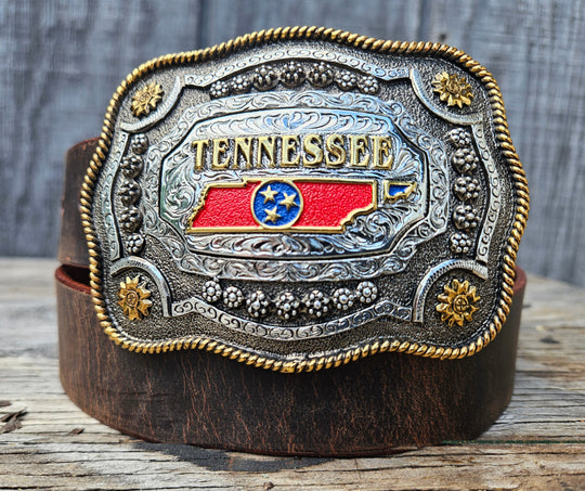 This Tennessee State Belt with Buckle Combo features a 1 1/2" strap. Choose color: Distressed Brown or Black. The edges are beveled and finished. Available lengths from 34" to 44". The buckle is an Antiqued brass colored Tennessee State Buckle snapped in place. Belt is handmade in our shop in Smyrna, TN, just outside of Nashville.