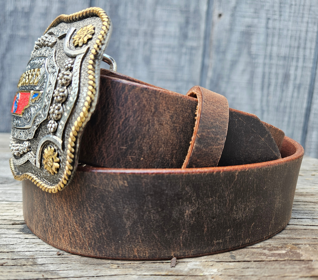 This Tennessee State Belt with Buckle Combo features a 1 1/2" strap. Choose color: Distressed Brown or Black. The edges are beveled and finished. Available lengths from 34" to 44". The buckle is an Antiqued brass colored Tennessee State Buckle snapped in place. Belt is handmade in our shop in Smyrna, TN, just outside of Nashville.